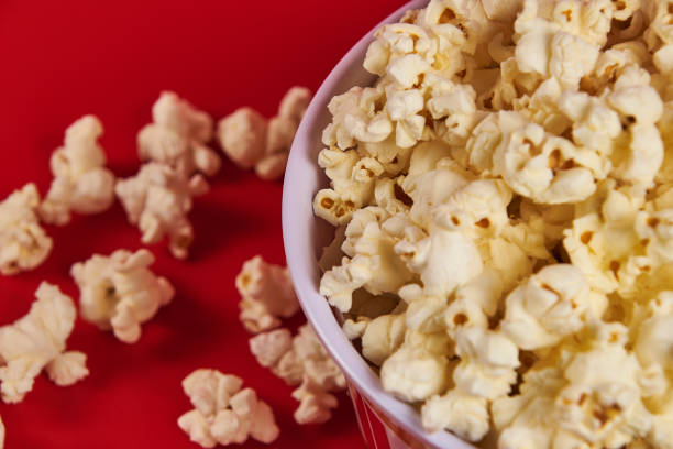 istock Bowl of popcorn on a red background 2178608432