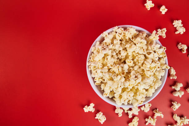 istock Bowl of popcorn on a red background 2178608439
