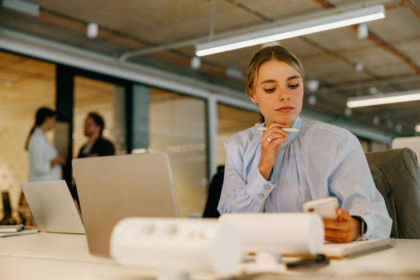 istock A Focused and Professional Woman Engaged in Work at a Contemporary Modern Office Environment 2178610363
