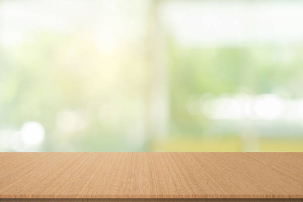 istock abstract blurred garden view form living room window with modern plain wood table counter background for show , promote ,design banner ads on display concept 2178613610