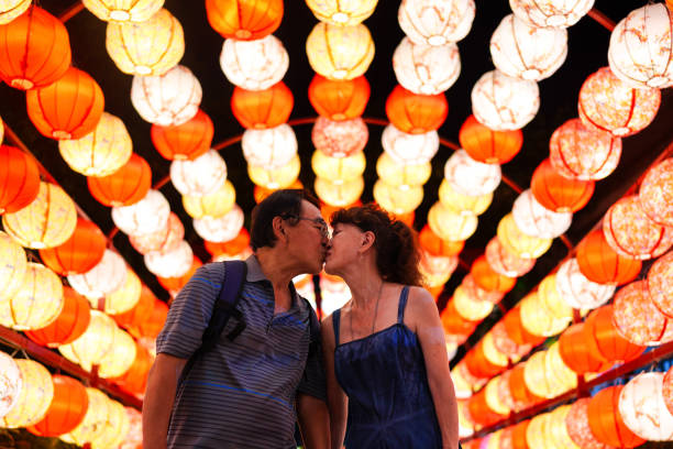 Romantic senior couple under colorful lanterns