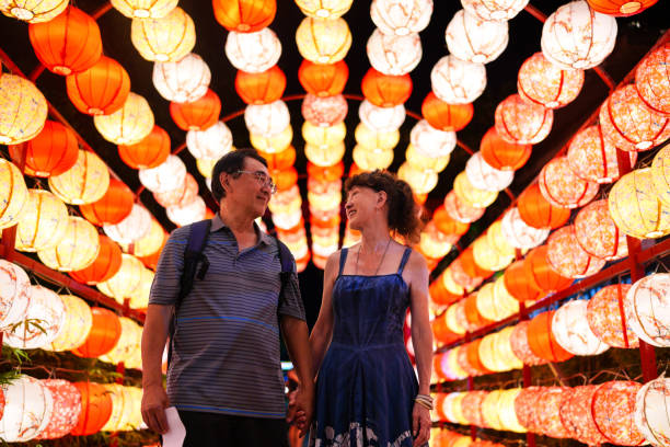 Senior couple under colorful lanterns