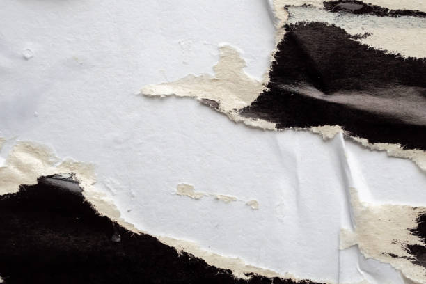 istock Old grunge ripped torn black paper poster surface texture background 2178616873
