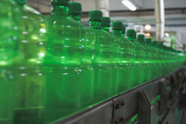 istock A conveyer belt with green plastic bottles for beverages 2178617372