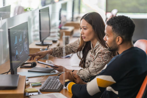 istock Asian Businesswoman and Businessman Analyzing Data on Computer 2178618316