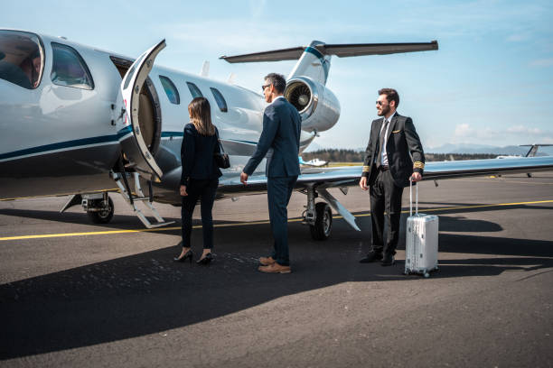 istock Asian Executives Meet Private Jet Pilot on Tarmac 2178619694