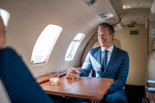 istock Smiling Asian Business Executive in Private Jet 2178619717