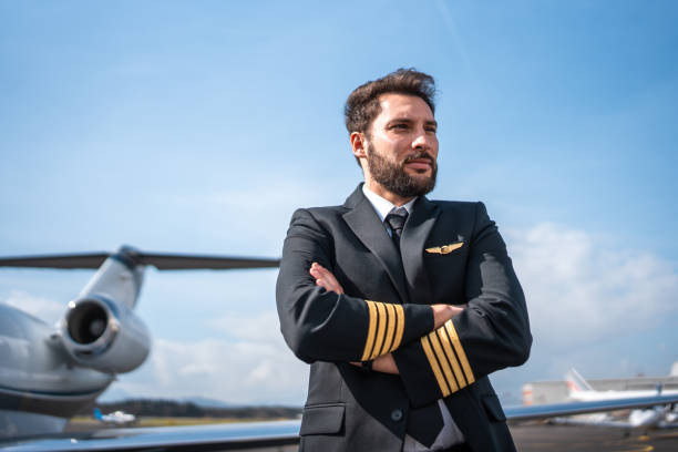 istock Confident Hispanic Airline Pilot by Aircraft 2178619728