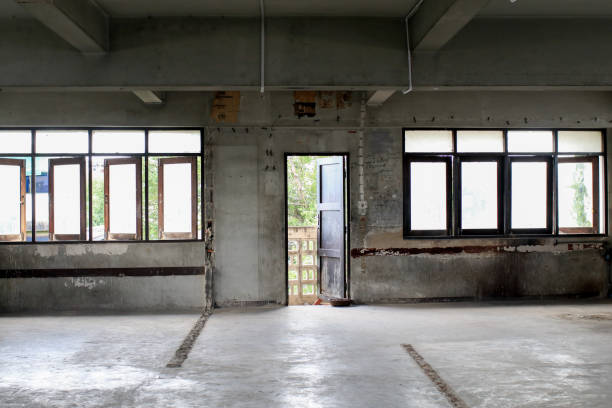 istock Empty hallway in abandon building interior with cement wall and broken window. 2178620999