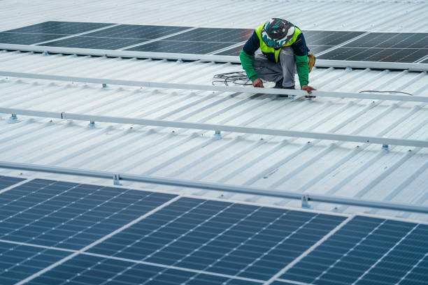 istock A worker installs or maintains solar panels on a rooftop. The image highlights renewable energy technology, solar power systems, and the role of workers in implementing sustainable energy solutions. 2178621110