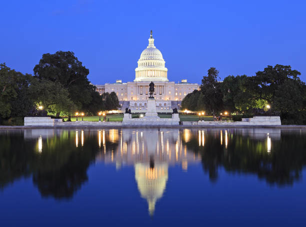 US Capitol illuminated at dusk in Washington DC with nice reflections into the water