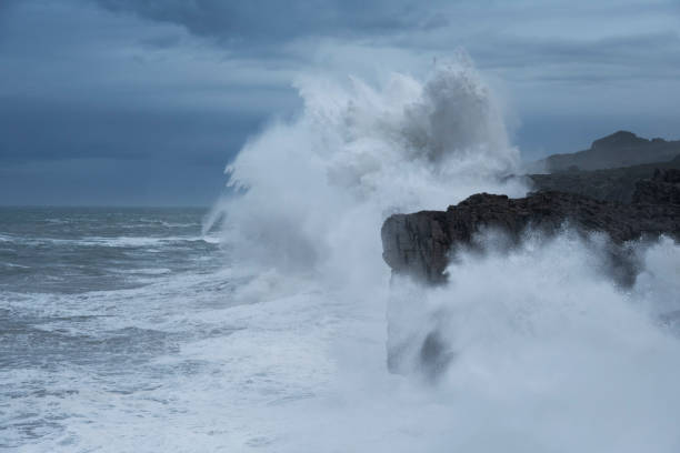 istock Large winter waves crash over sea cliffs at Buelna, Asturias, Spain 2178630436
