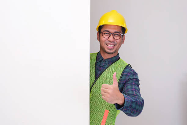 istock A construction worker peeking behind wall give thumbs up with happy expression 2178632097