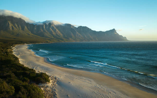 Experience the breathtaking beauty of Cape Town, where majestic mountains rise dramatically against the shimmering sea. This stunning landscape captures the unique interplay between rugged terrain and the tranquil ocean, making it a perfect addition to any travel or nature collection. Ideal for projects focused on adventure, tourism, or the natural wonders of South Africa.