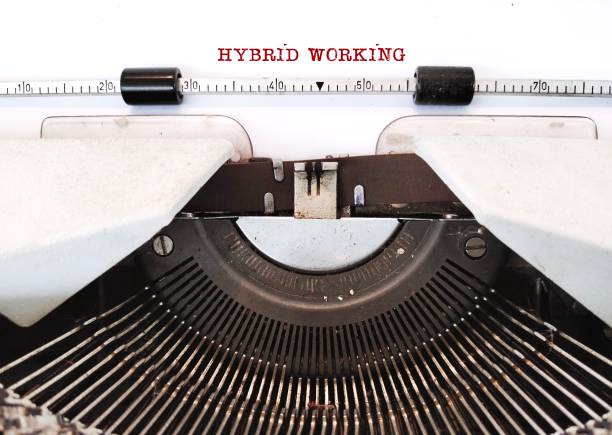 istock Vintage typewriter with red typed text HYBRID WORKING, means flexible approach combines working in office and working from home with flexibility and supports work schedules 2178636124