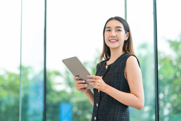 istock Young Businesswoman Using A Tablet, Looking Away Smiling 2178636336