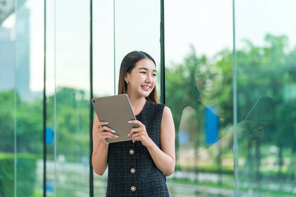 istock Young Businesswoman Using A Tablet, Looking Away Smiling 2178636347