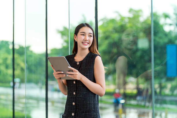 istock Young Businesswoman Using A Tablet, Looking Away Smiling 2178636356