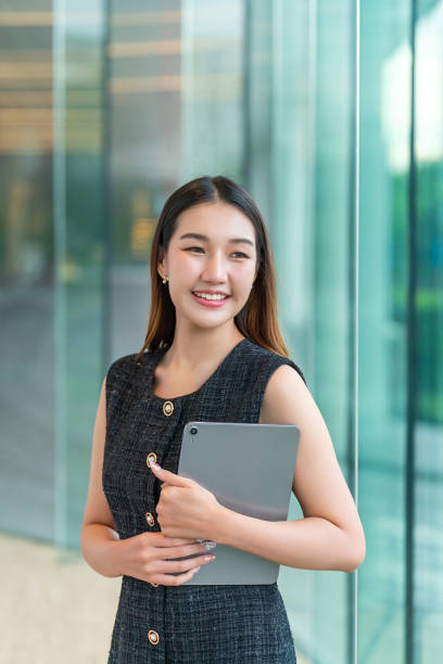 istock Young Woman Holding A Tablet, Looking Away Smiling 2178636375