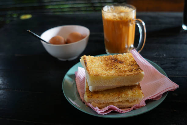 istock Kaya toast butter with teh tarik and half boiled eggs. 2178640730