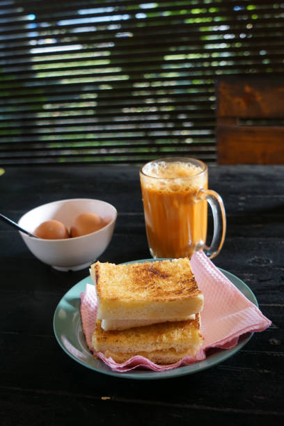 istock Kaya toast butter with teh tarik and half boiled eggs. 2178640736
