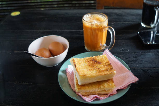 istock Kaya toast butter with teh tarik and half boiled eggs. 2178640747