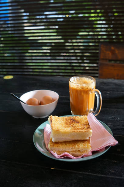 istock Kaya toast butter with teh tarik and half boiled eggs. 2178640754