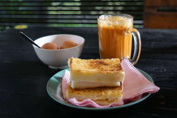 Kaya toast butter with teh tarik and half boiled eggs.