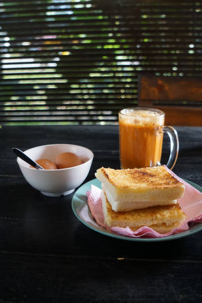 istock Kaya toast butter with teh tarik and half boiled eggs. 2178641330