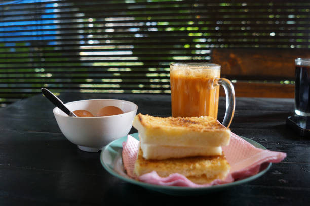 istock Kaya toast butter with teh tarik and half boiled eggs. 2178641344