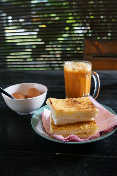 istock Kaya toast butter with teh tarik and half boiled eggs. 2178641389