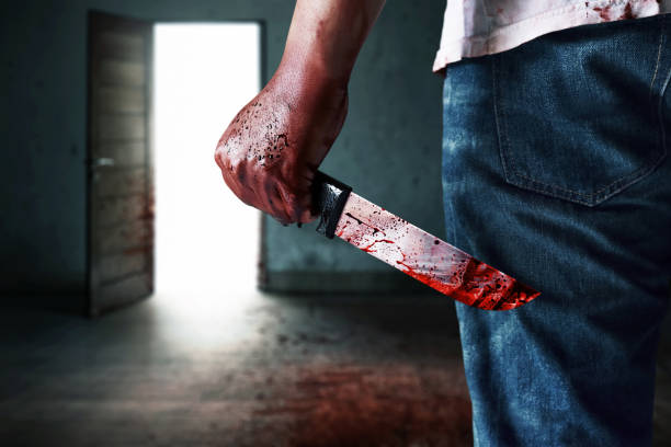 istock Psycho serial killer holding bloody knife in broken room, Halloween theme 2178643842