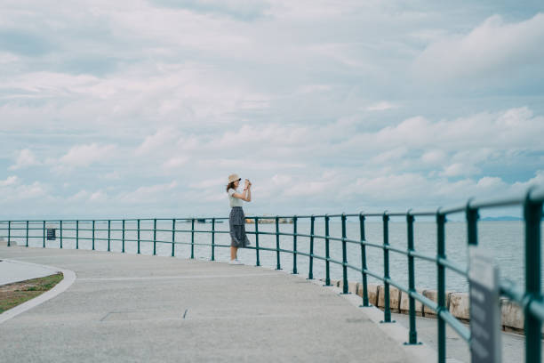 Young Asian Chinese woman taking photo near Penang City Hall