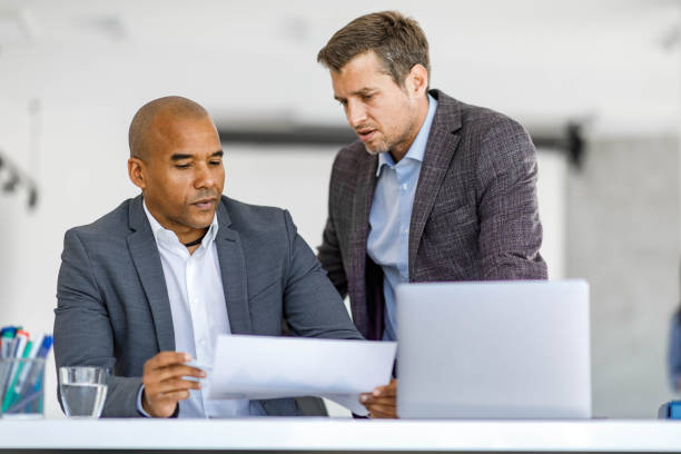 istock Male entrepreneurs analyzing business reports in the office. 2178646186