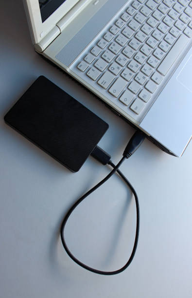 istock Black portable HDD with inserted USB cable to laptop top point of view 2178647274