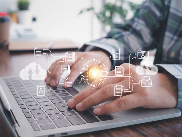 istock Businessman use computer laptop to submit online electronic document folders from corporate databases connected to the head office. Technology background. 2178650672