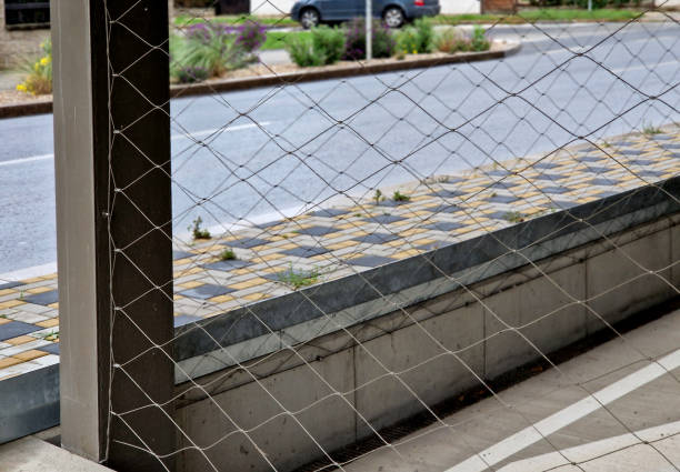 istock front of the facade with balconies is tensioned cable network covering entire building. electrical tension insulators. corners of building into an arch, rounded. braided network. pebbles 2178651892