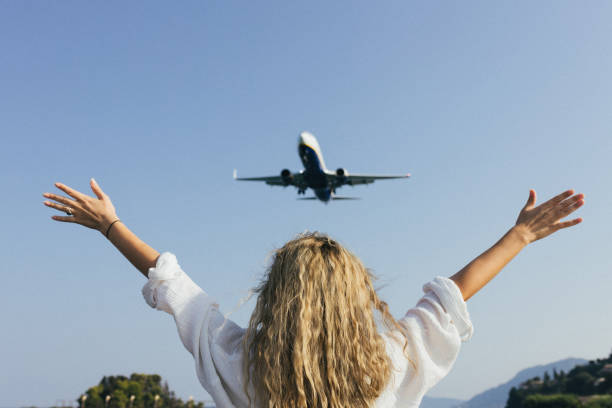 istock A woman with her arms raised above her head waves 2178654368