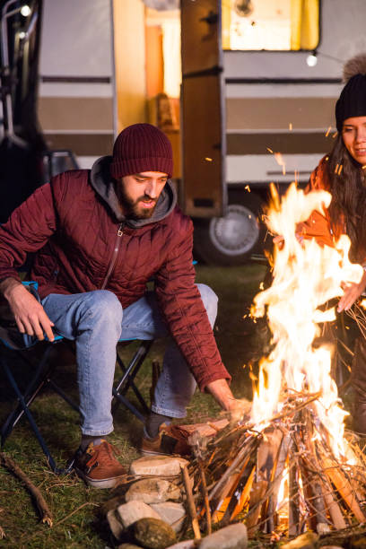 istock Man making the camp fire stronger in a cold night of autumn 2178657728