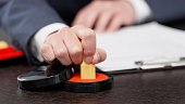 the-hands-of-a-businessman-stamping-a-contract.jpg?b=1&s=170x170&k=20&c=mpm97QBaQ1Giiq8wqK2iY_CUdW6Jnvi6Eim_eRehyHI=