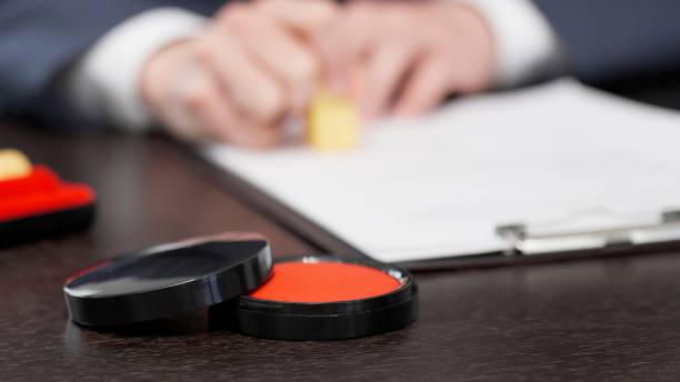 istock The hands of a businessman stamping a contract 2178657982