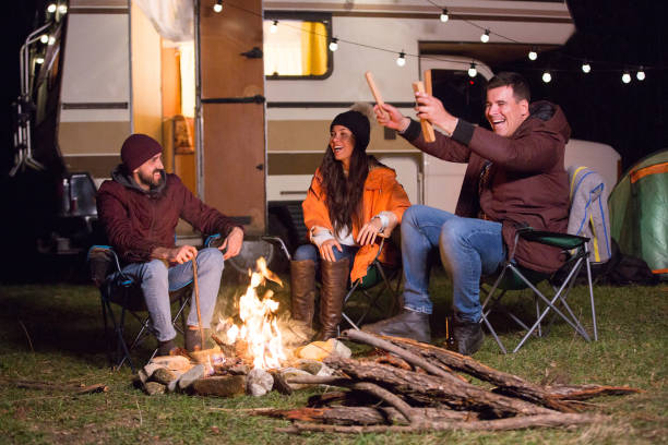 istock Group of close friends warming up around camp fire 2178658098