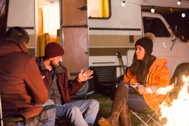 istock Bearded man telling a story to his friends around camp fire 2178658177