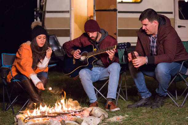 istock Caucasian girl roasting marshmallow over camp fire 2178658335