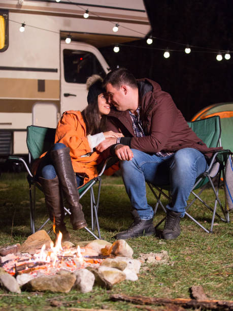 istock Beautiful young couple warming together near camp fire 2178658440