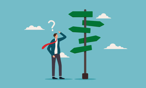 istock Business decision making. Confused businessman at crossroads, pondering multiple directional signs. Suitable for business decisions, choices, uncertainty, and career guidance concepts 2178659423