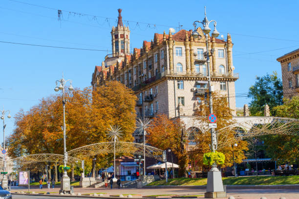 Kyiv, Ukraine - October 9, 2024: View of a historic building in Kyiv adorned with autumn leaves, showcasing architectural details and street activity.