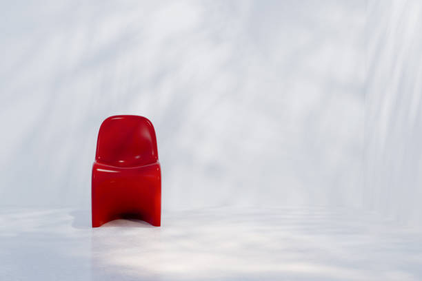 Front view of modern red chair in minimalist setting.