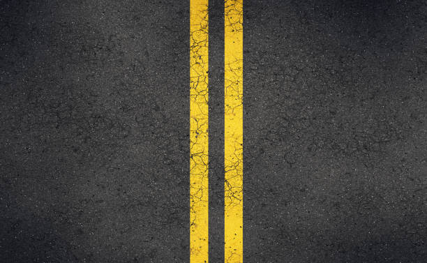 istock Asphalt road with bright yellow double lines and cracks 2178660472