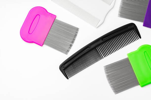 Colorful plastic and metal combs on a white background close up